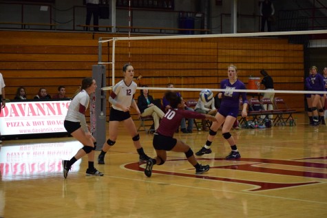 Miquel Green playing the ball with teammates Jamie Rubbelke and Beth Goodman looking on during their code red game on Oct. 9.