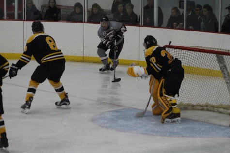 Senior forward and team captain Brandon Zurn gets the puck and moves it forward in the Pipers game against UW-Superior on Saturday, Nov. 14.