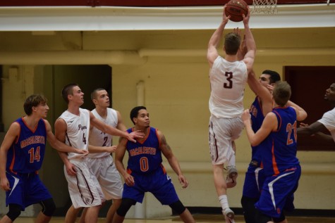 Junior forward Dylan See-Rockers extending over Scot defenders to get a basket. He scored 16 points against Macalester and claimed five rebounds.